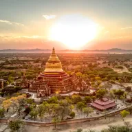 Golden pagoda in the evening light above the plain of Bagan