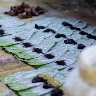 Betel leaves laid out with dark paste