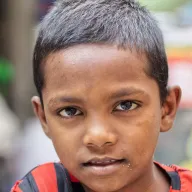 Portrait of a boy in a red and black striped shirt