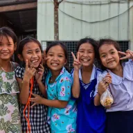 Five girls making peace signs