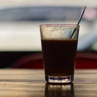 Glass of iced coffee with a straw