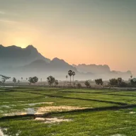 Sunrise over karst mountains and rice fields
