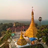 Golden pagoda complex on a hill, from above