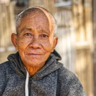 Portrait of an elderly man in a hoodie