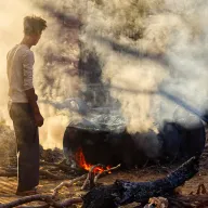 Man at a fireplace in the smoke